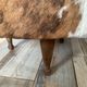 Tripod storage pouffe in wood and cowhide from the 60s-70s.