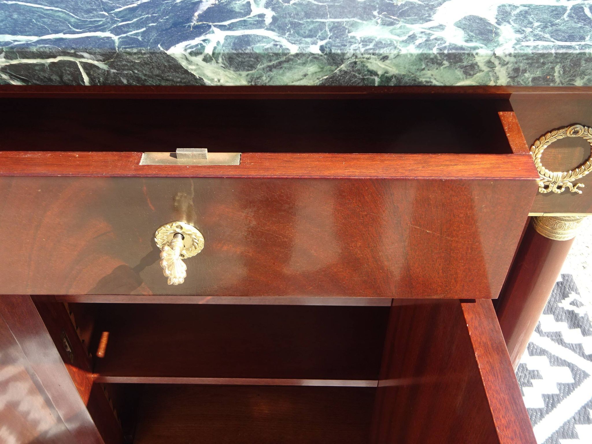 Flamed mahogany enfilade with sea green marble in Empire style.