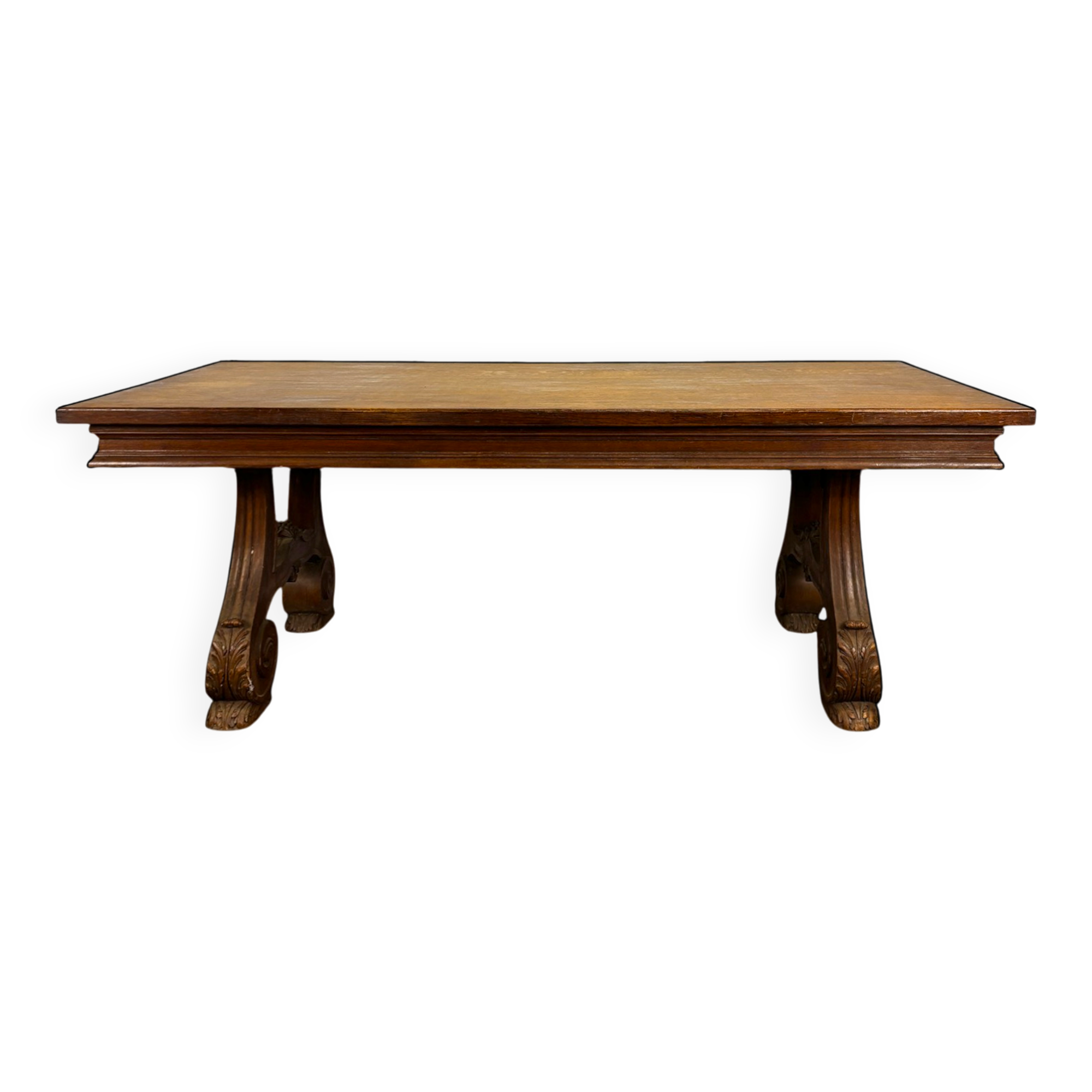 Renaissance-style oak dining table with lyre legs.