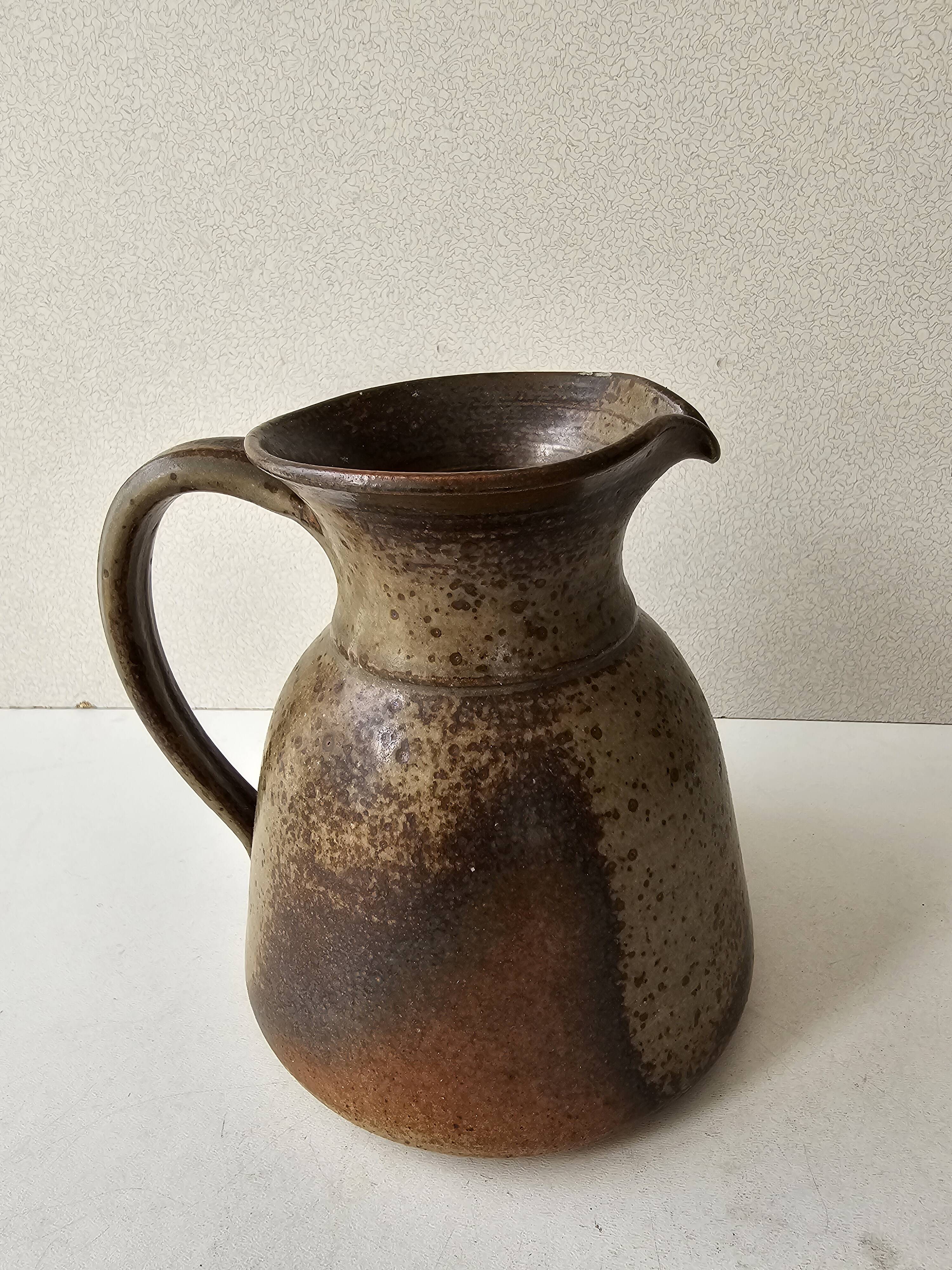Pyrithed stoneware ceramic pitcher signed GRh. (signature to be identified)