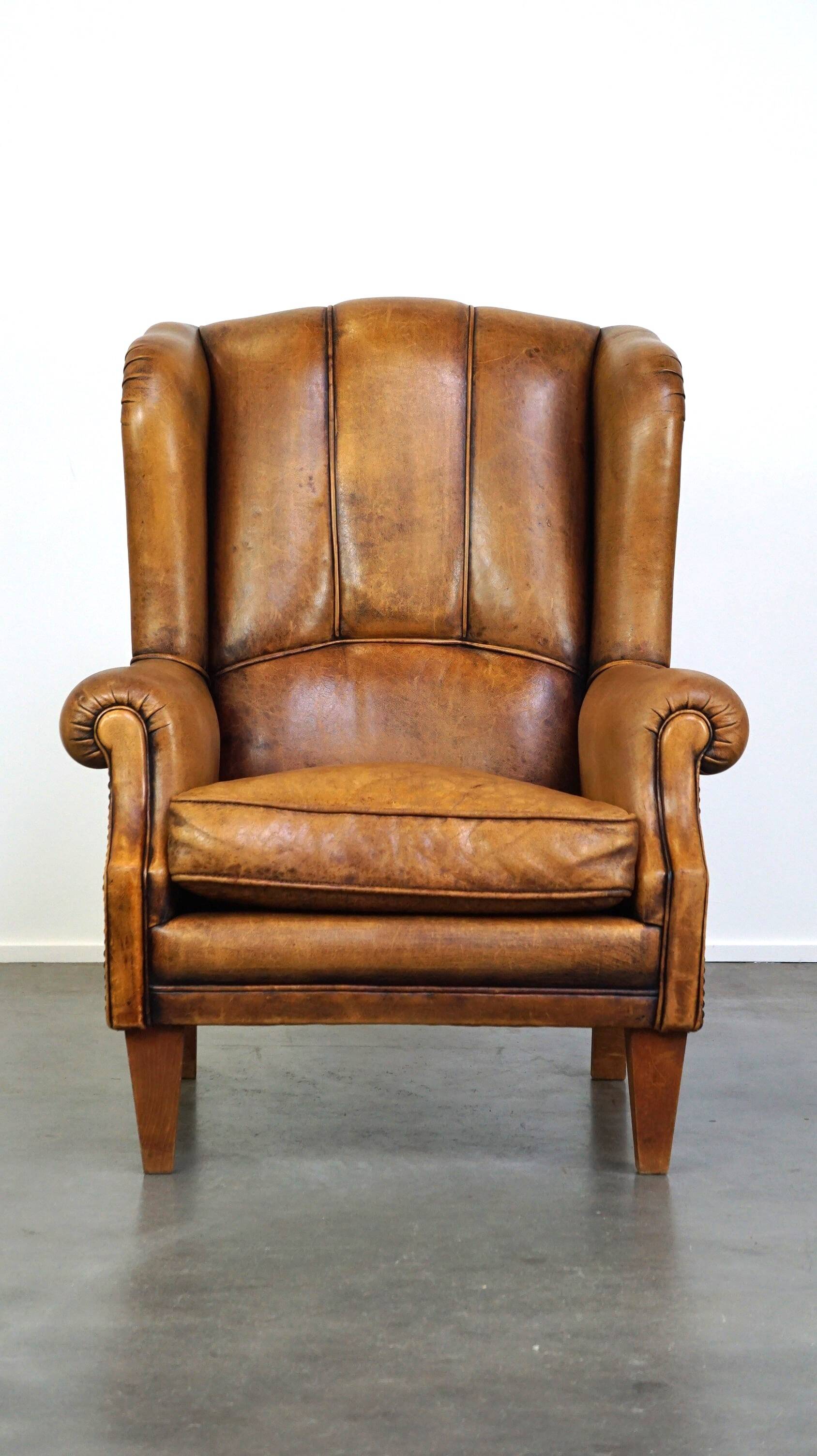 Sheepskin wingback chair with a unique design and a beautiful patina