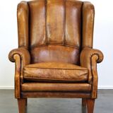 Sheepskin wingback chair with a unique design and a beautiful patina