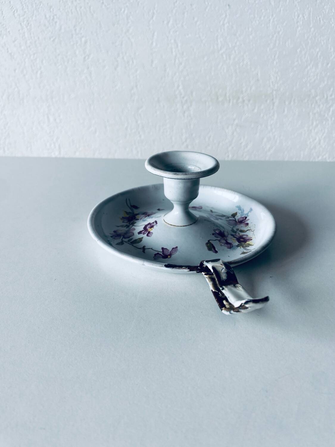 Antique enamelled metal candle holder