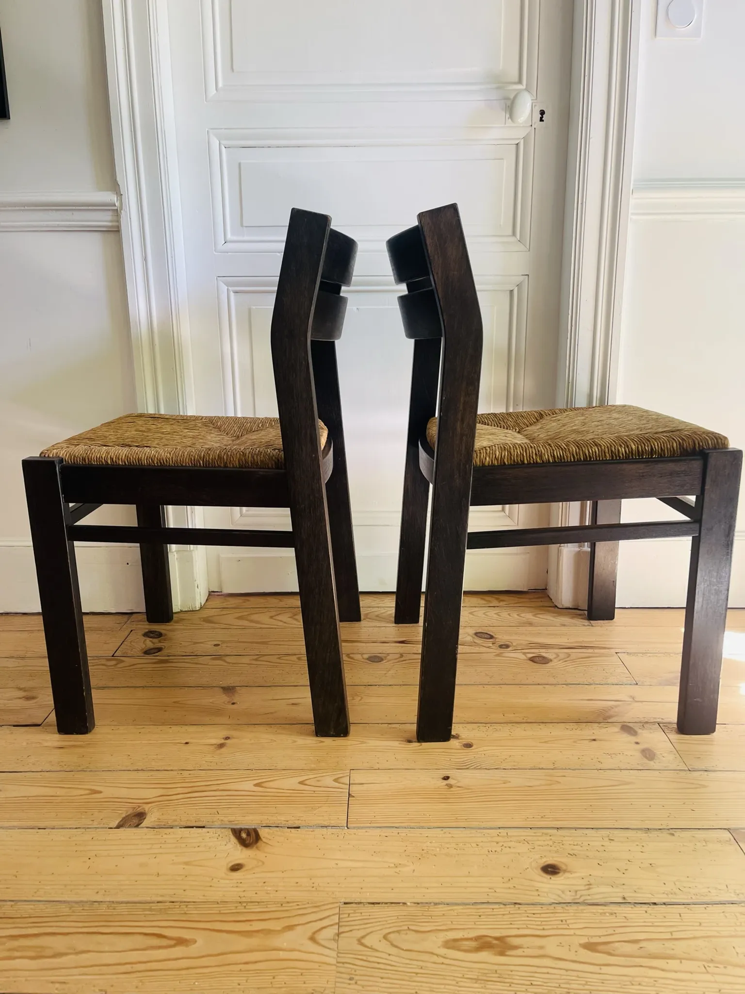 Pair of straw-seated wooden chairs in the regain style.