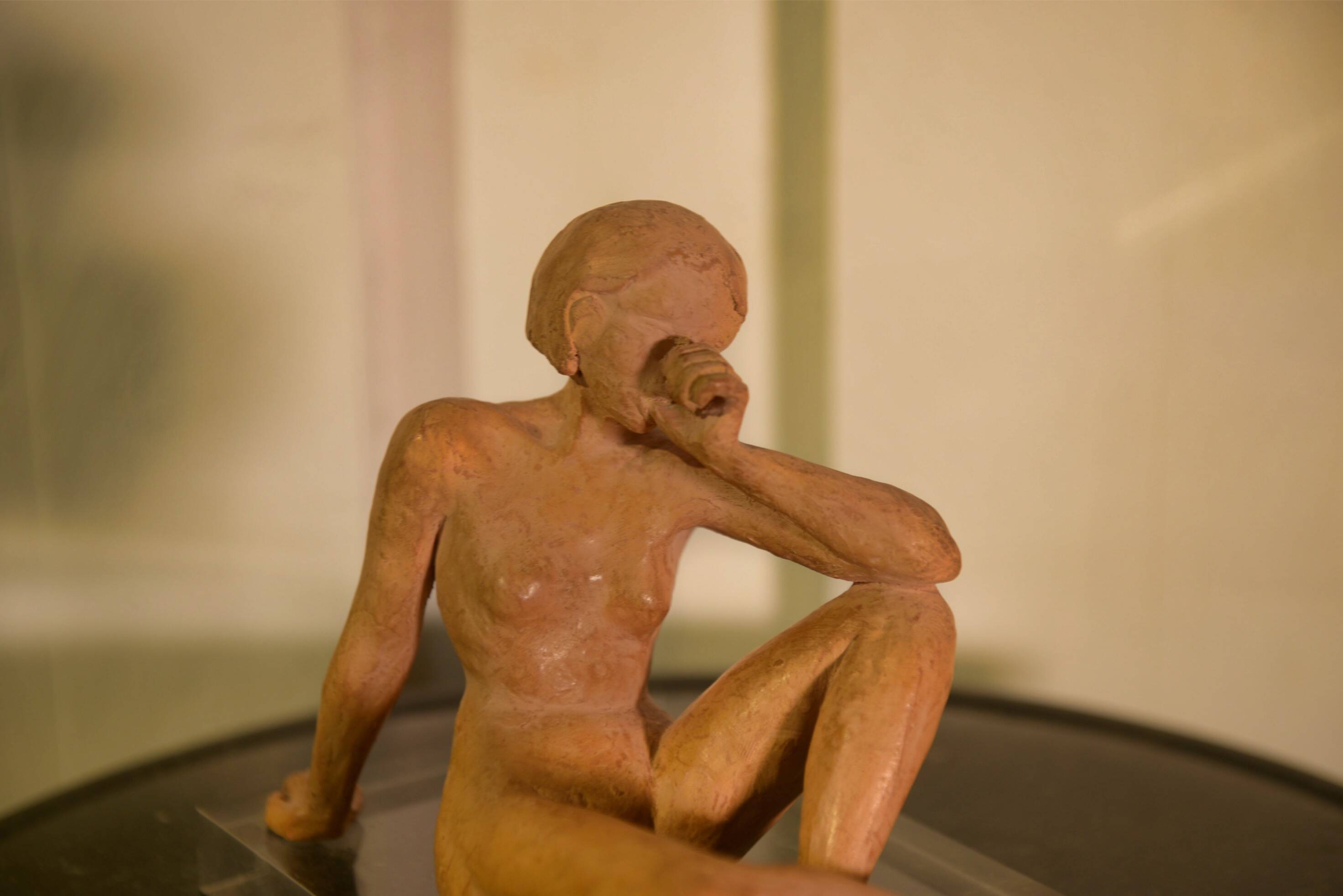 Terracotta sculpture of a seated woman by Norbert Treca contemporary art.
