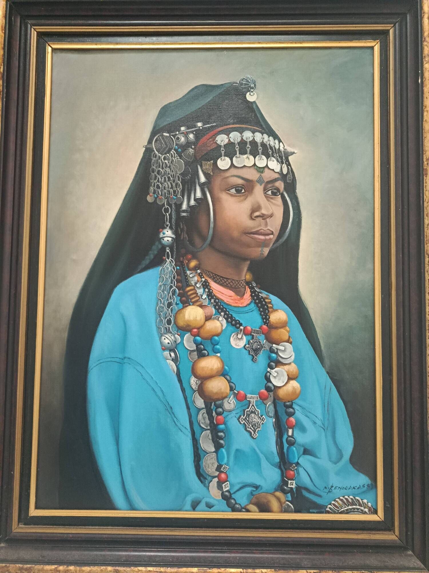 Portrait of a young Moroccan woman in traditional attire and adornments.