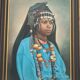 Portrait of a young Moroccan woman in traditional attire and adornments.