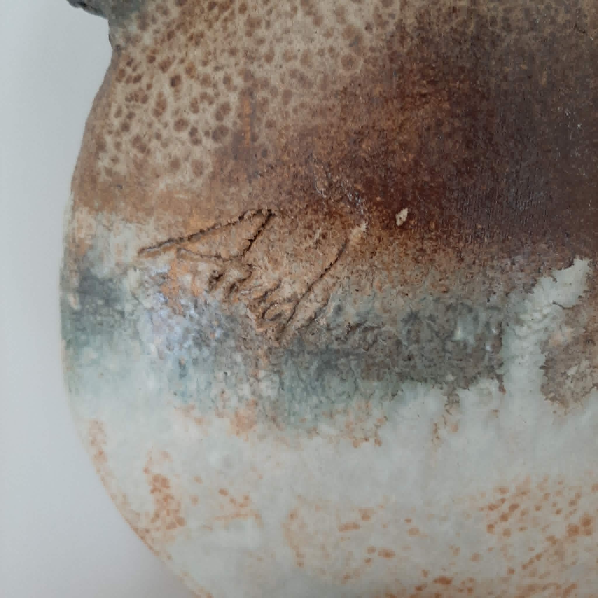 Oval/round pottery on base signed