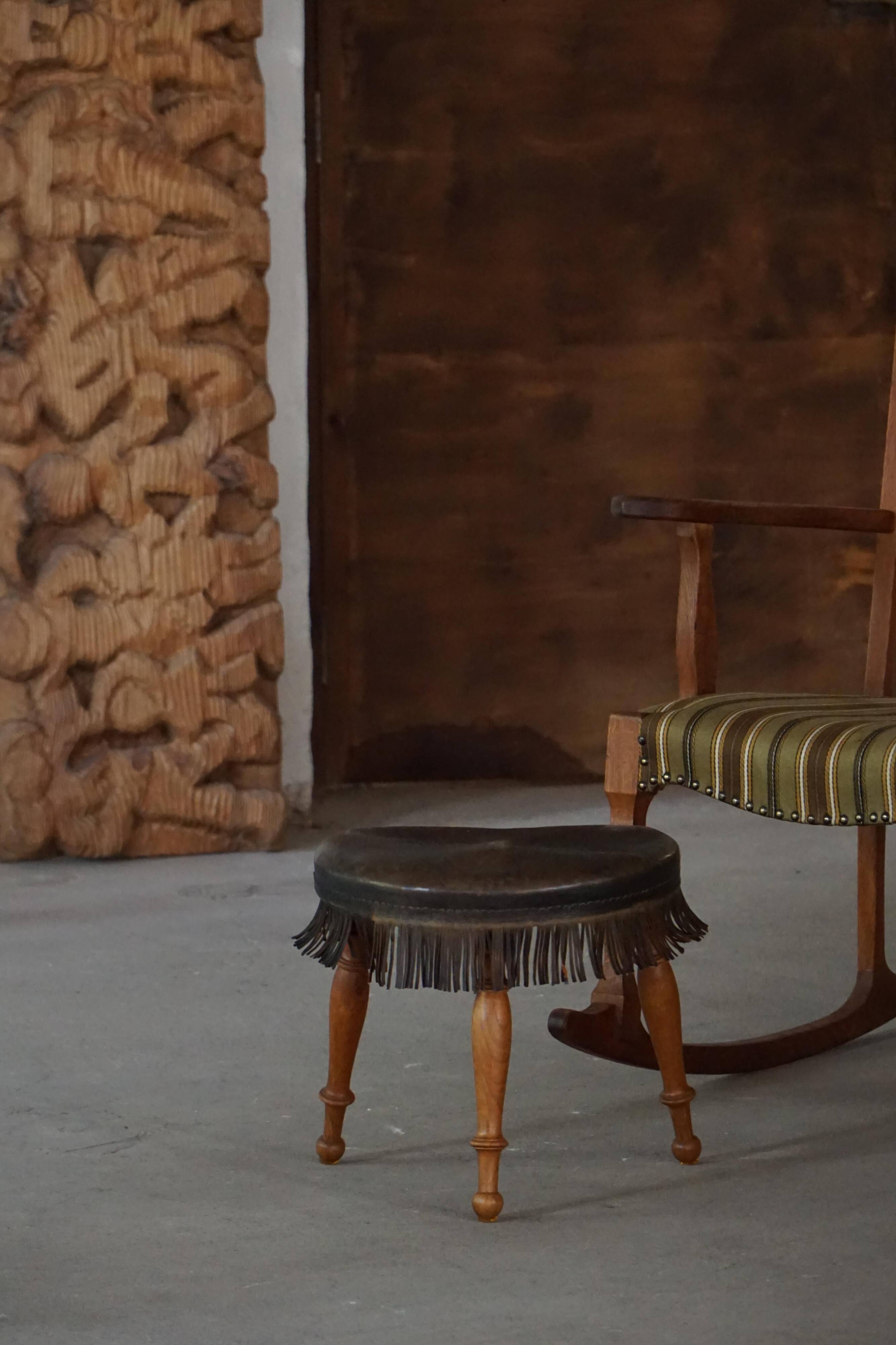 Danish oak tripod stool from the early 20th century with leather fringe, 1930s.