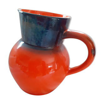 Pitcher in glazed sandstone. orange background and fade colors at the neckline.