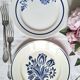 Mismatched antique flat plates accompanied by dishes.
