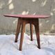 Small Scandinavian side table with wood and pink tiles, with tapered legs.