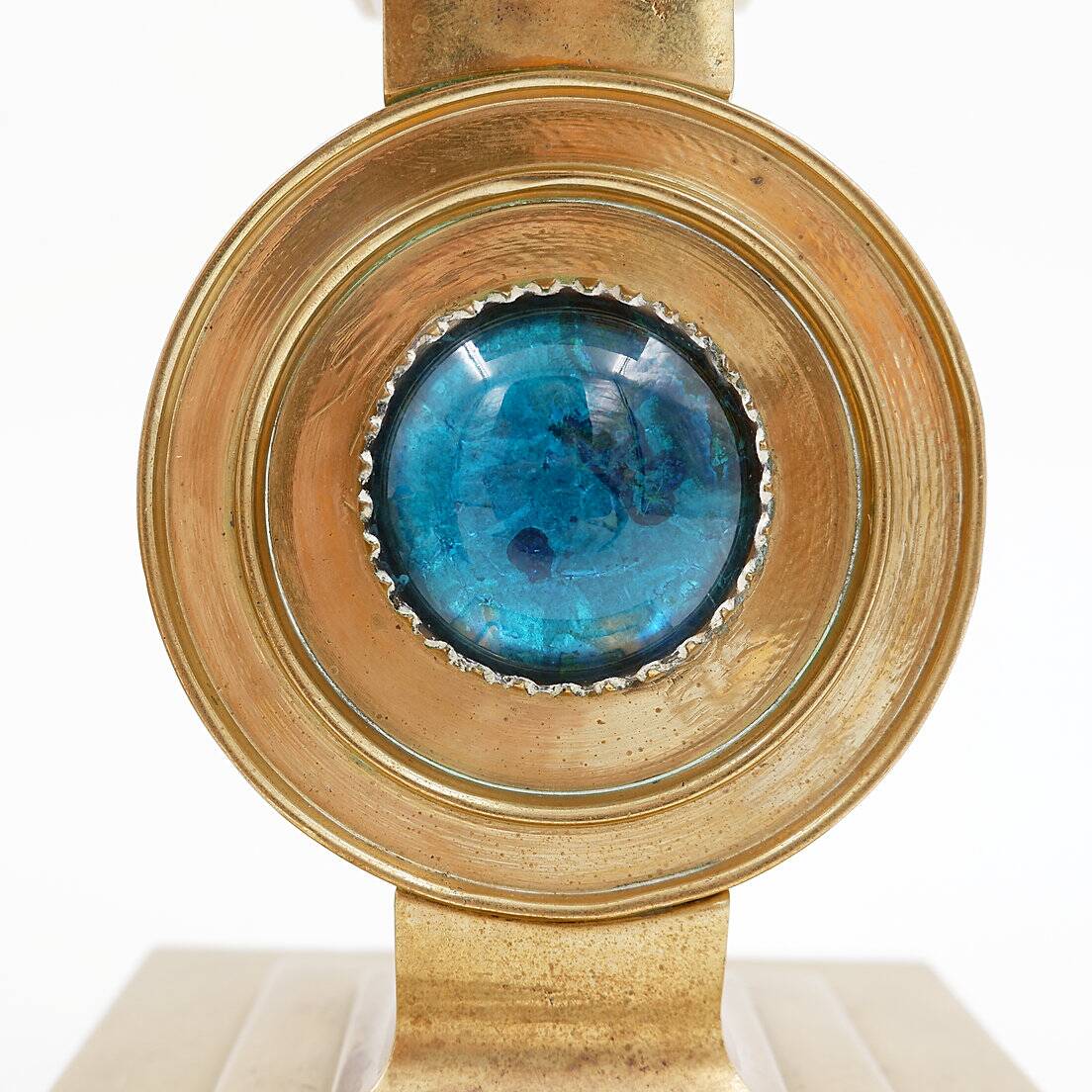 Pair of brass candlesticks decorated with a blue stone inlaid in the center