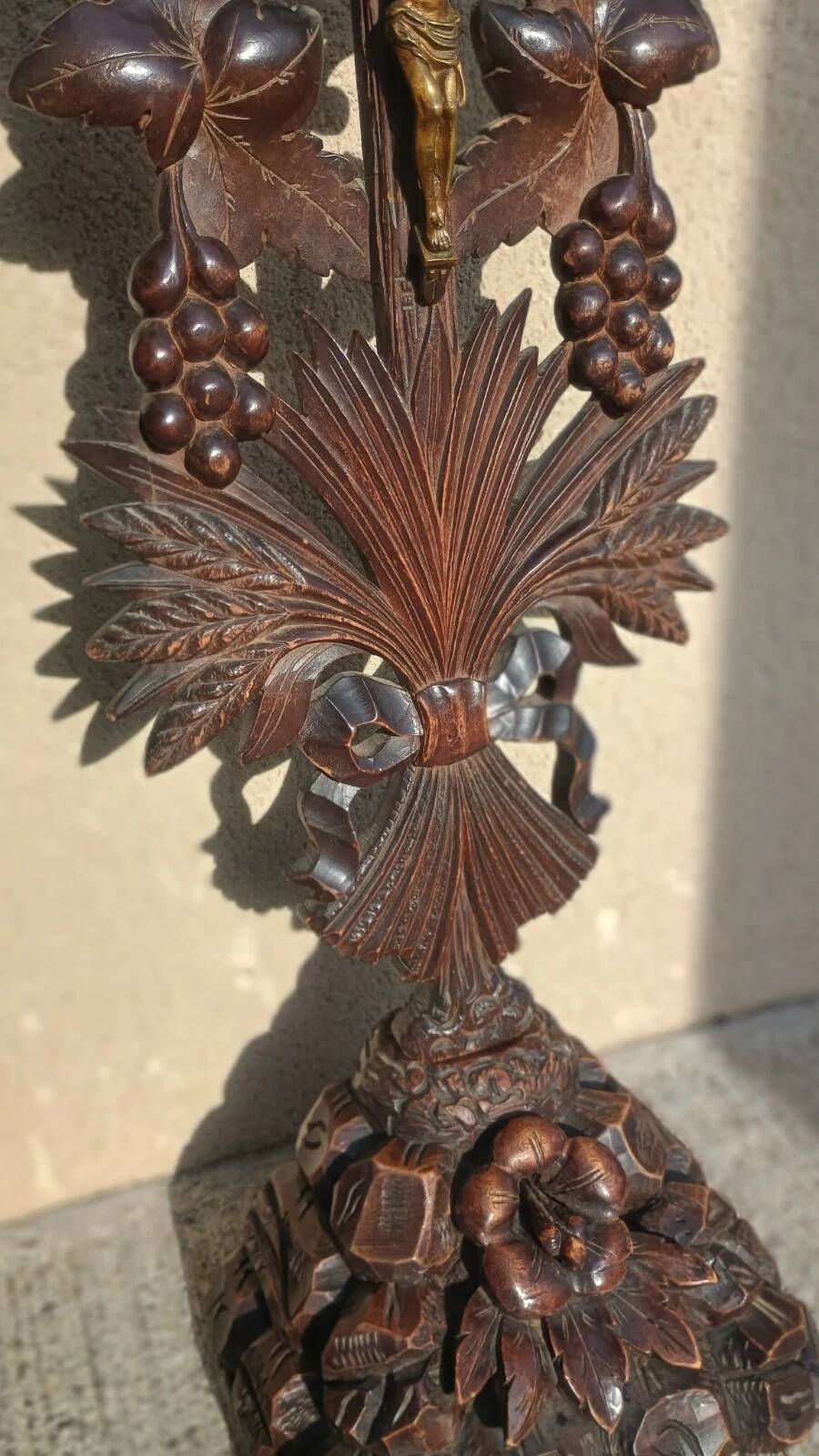 Antique wooden crucifix carved from the Black Forest with grapes and leaves.