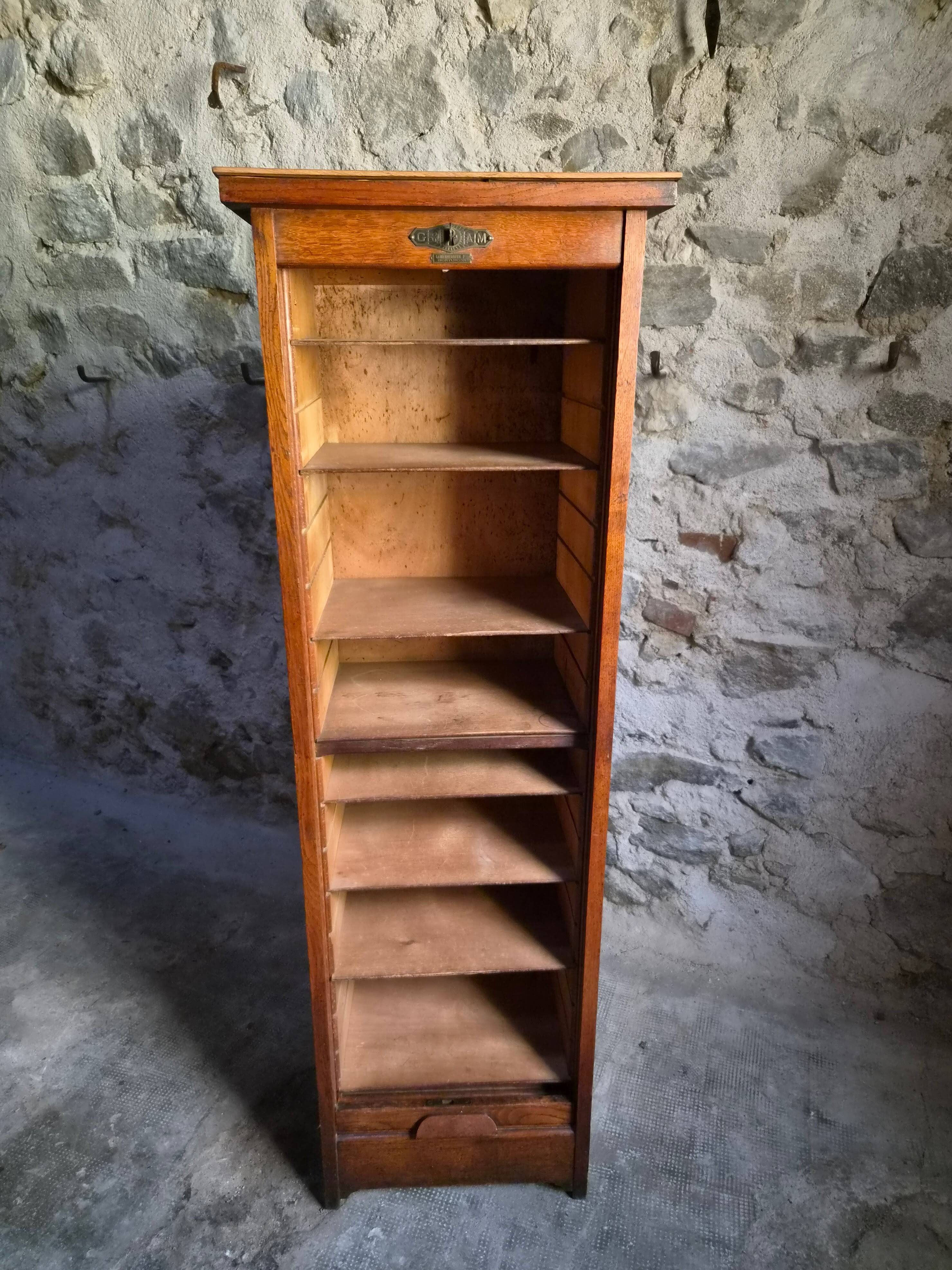 French antique wardrobe with curtain in oak, circa 1920–1930.