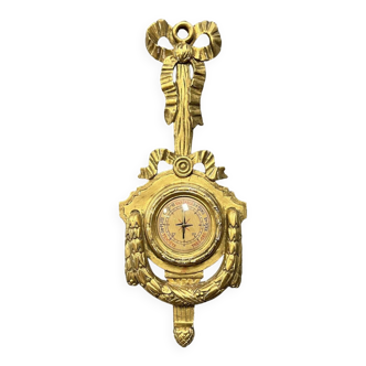 Louis XVI style barometer in gilded wood and carved with knotted draperies