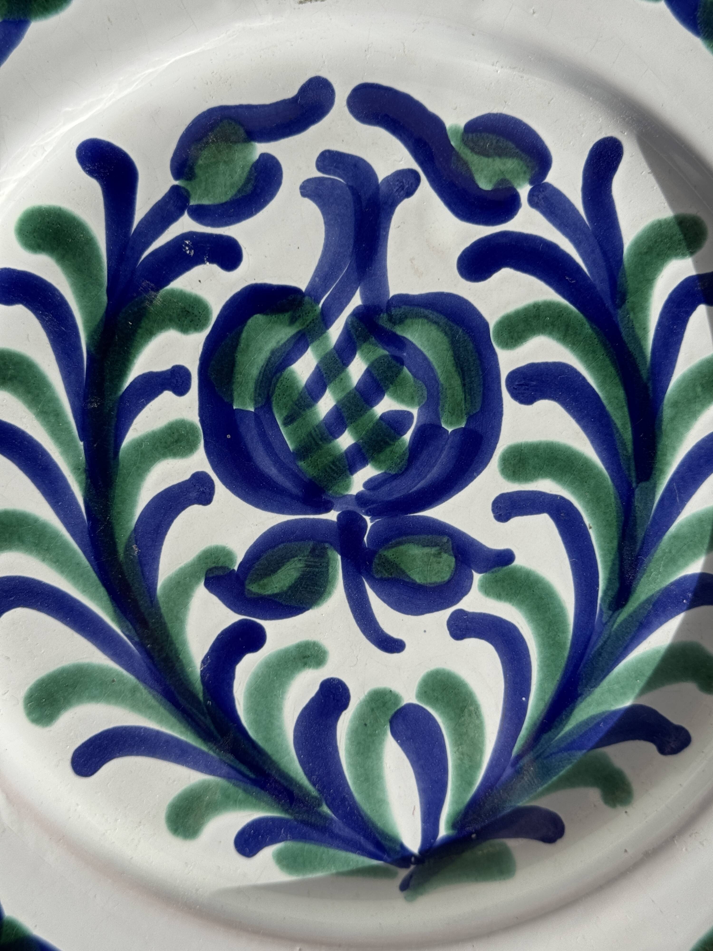 Artesania Alvarez Spanish plate in terracotta with blue plant motif.
