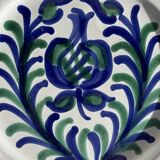Artesania Alvarez Spanish plate in terracotta with blue plant motif.