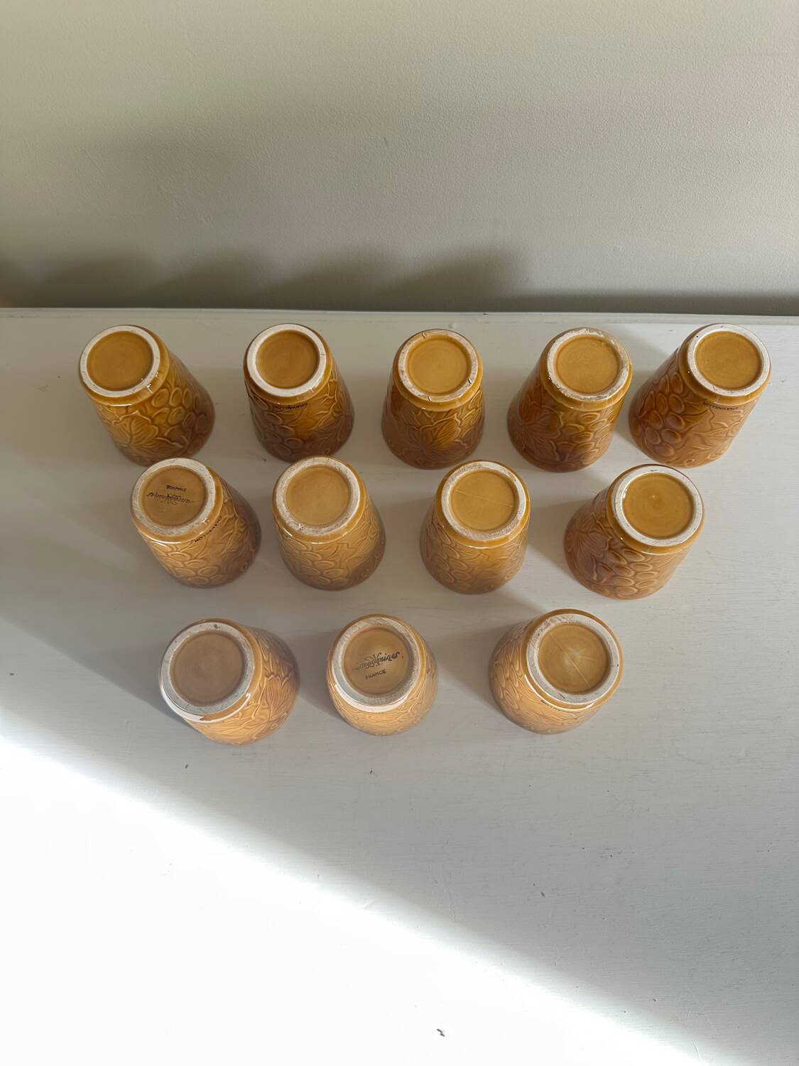 Set of 12 ochre Chavaillon de Sarreguemines cups