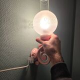 Original wall lights in pink enamelled cast iron with frosted glass globes.