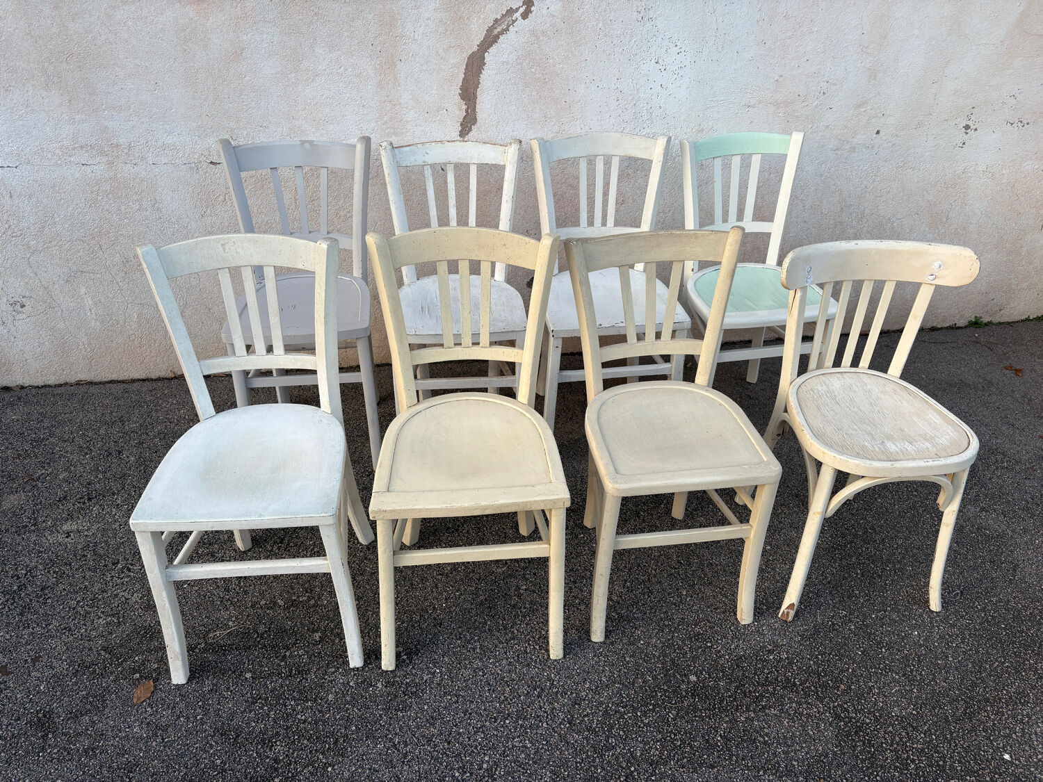 Set of 8 mismatched white bistro chairs