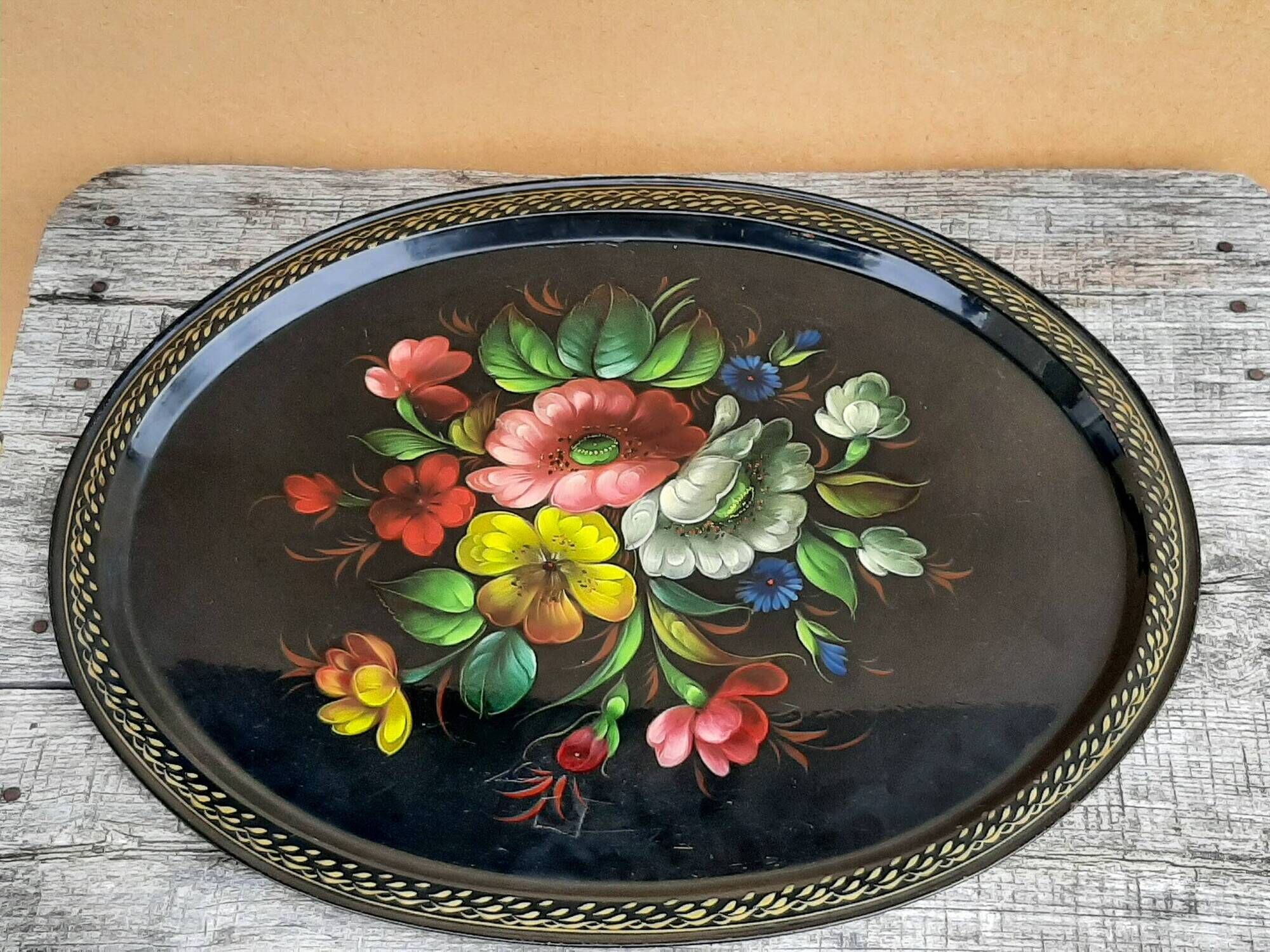 Black lacquered metal tray with multicoloured vintage Russian floral decoration.