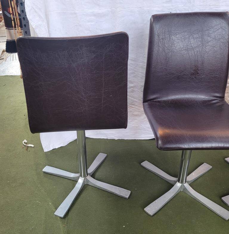 Set of 4 metal and imitation leather swivel chairs.