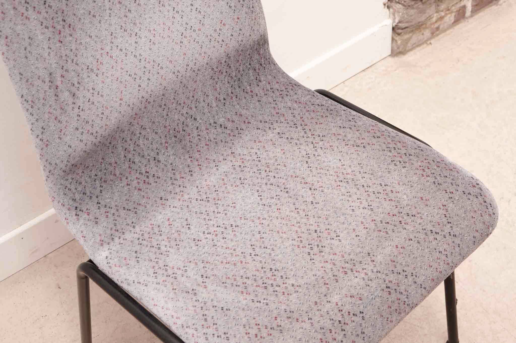 Grey fabric chair with pattern and black legs