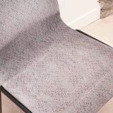 Grey fabric chair with pattern and black legs