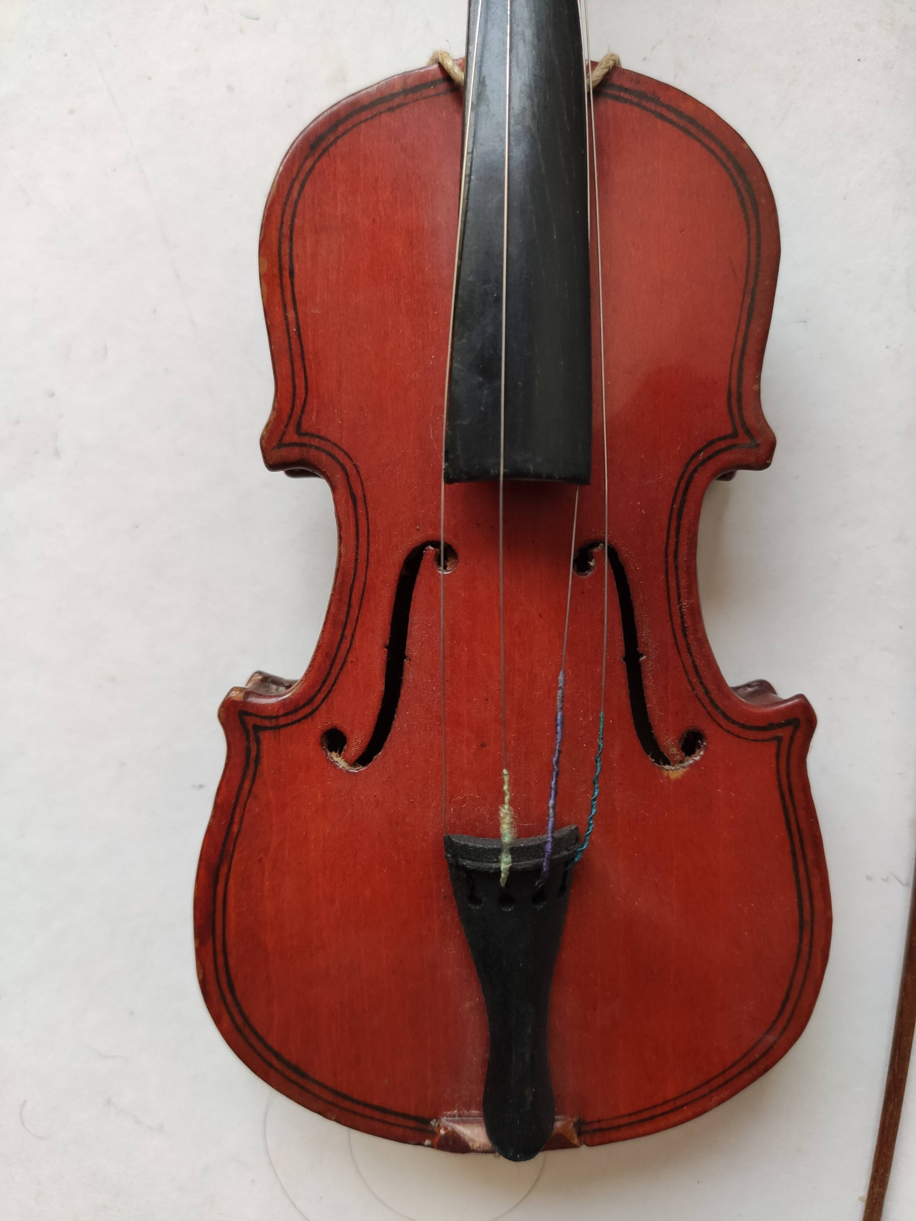 violin and decorative archer in antique varnished wood