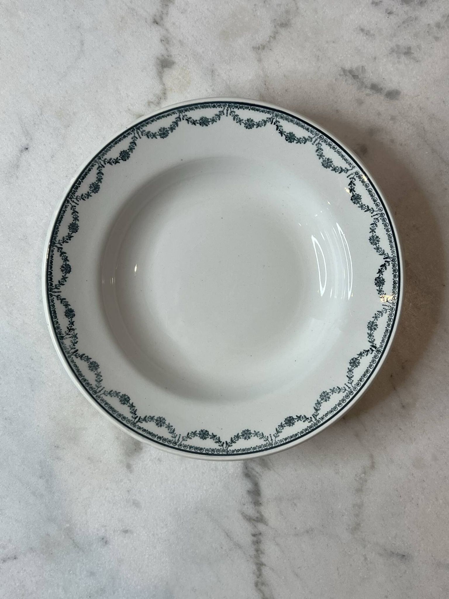 Set of 12 deep plates Saint Amand with floral garland decoration.