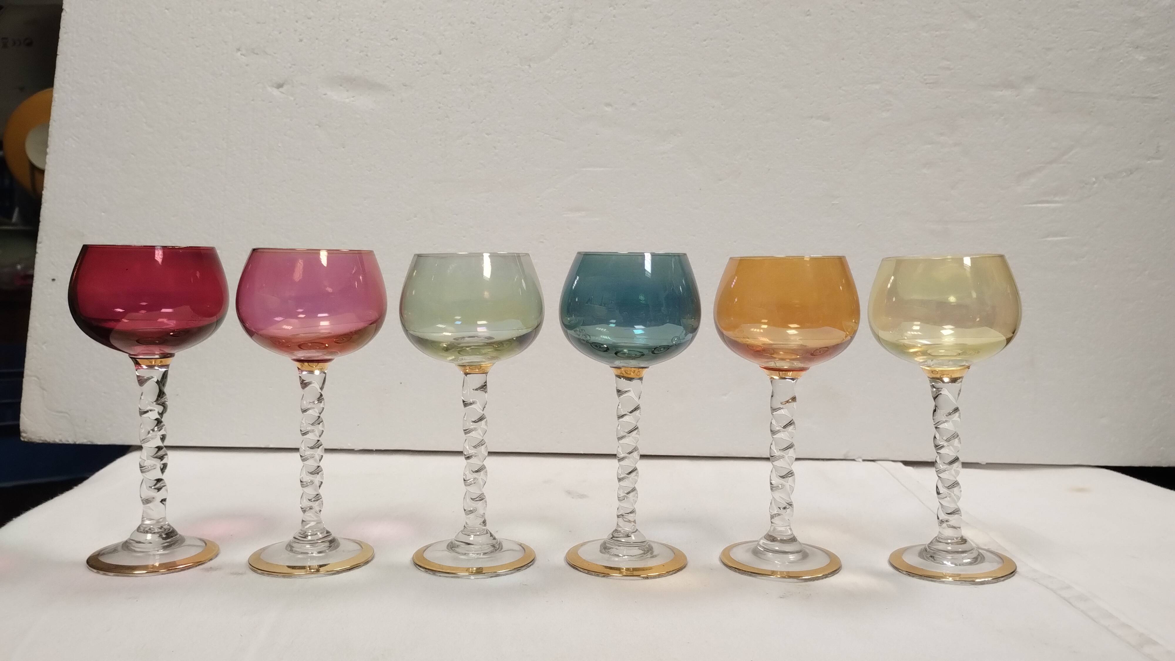 Set of 6 colored crystal stemmed glasses with gold twisted foot.