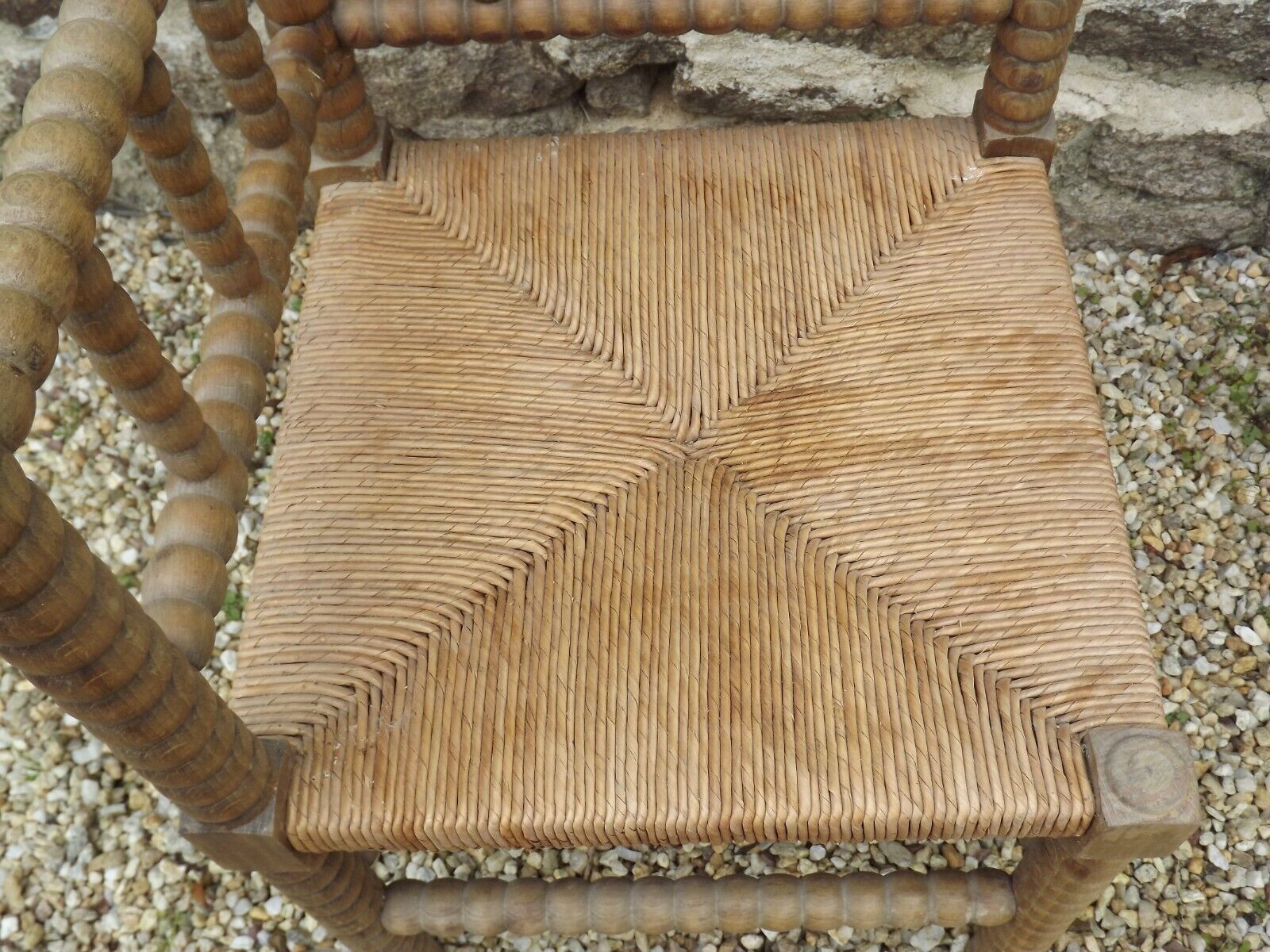 French antique turned wooden bobbin chair with rush seat
