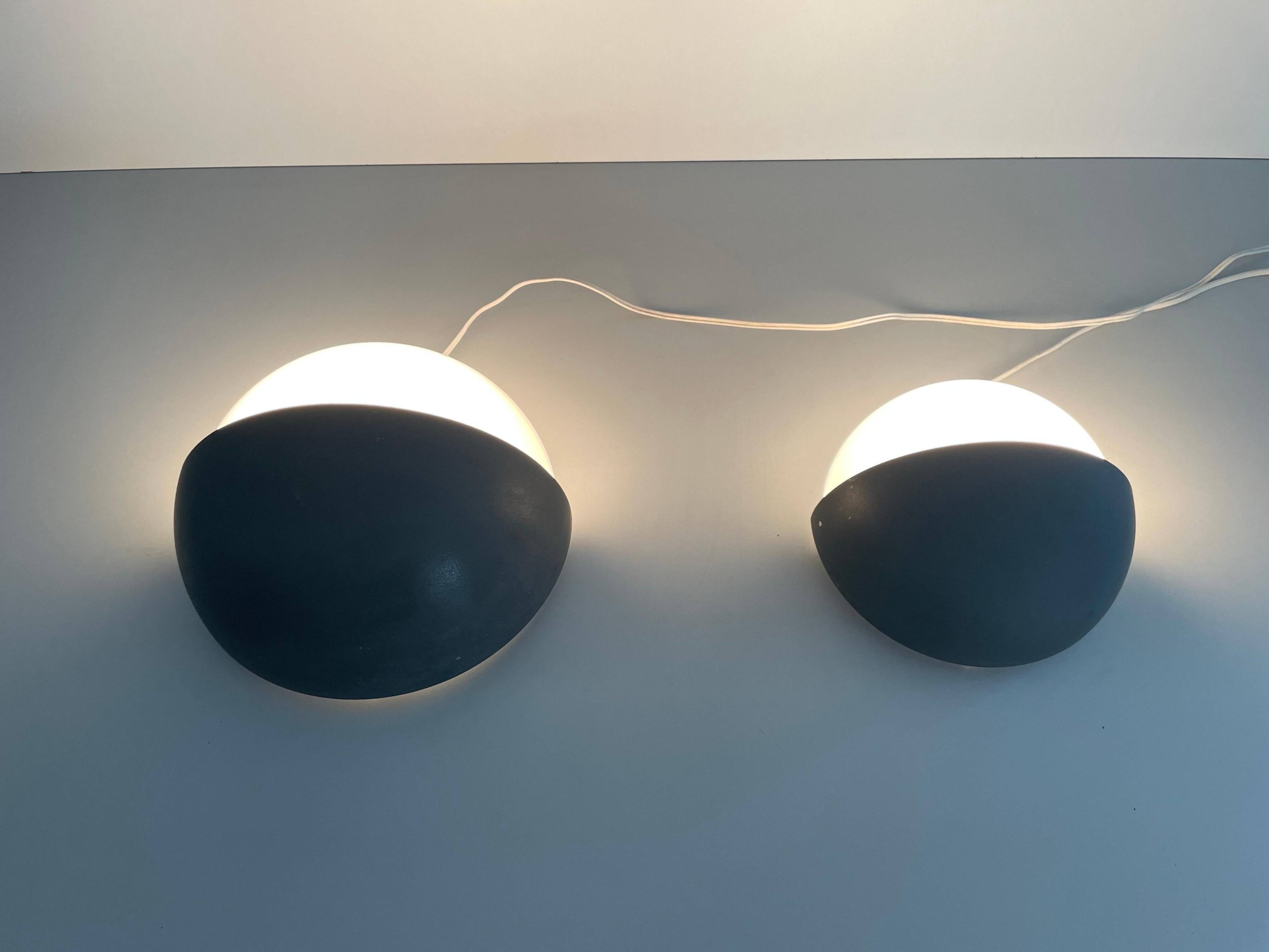 Round black metal wall lights, small and large set, by Bega, 1970s, Germany.