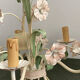 Five-branch enamelled metal chandelier with pink flower decoration.