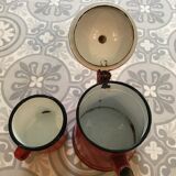 Old pitcher and cup in enamelled sheet metal