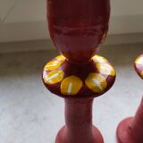 A pair of glazed earthenware candlesticks.