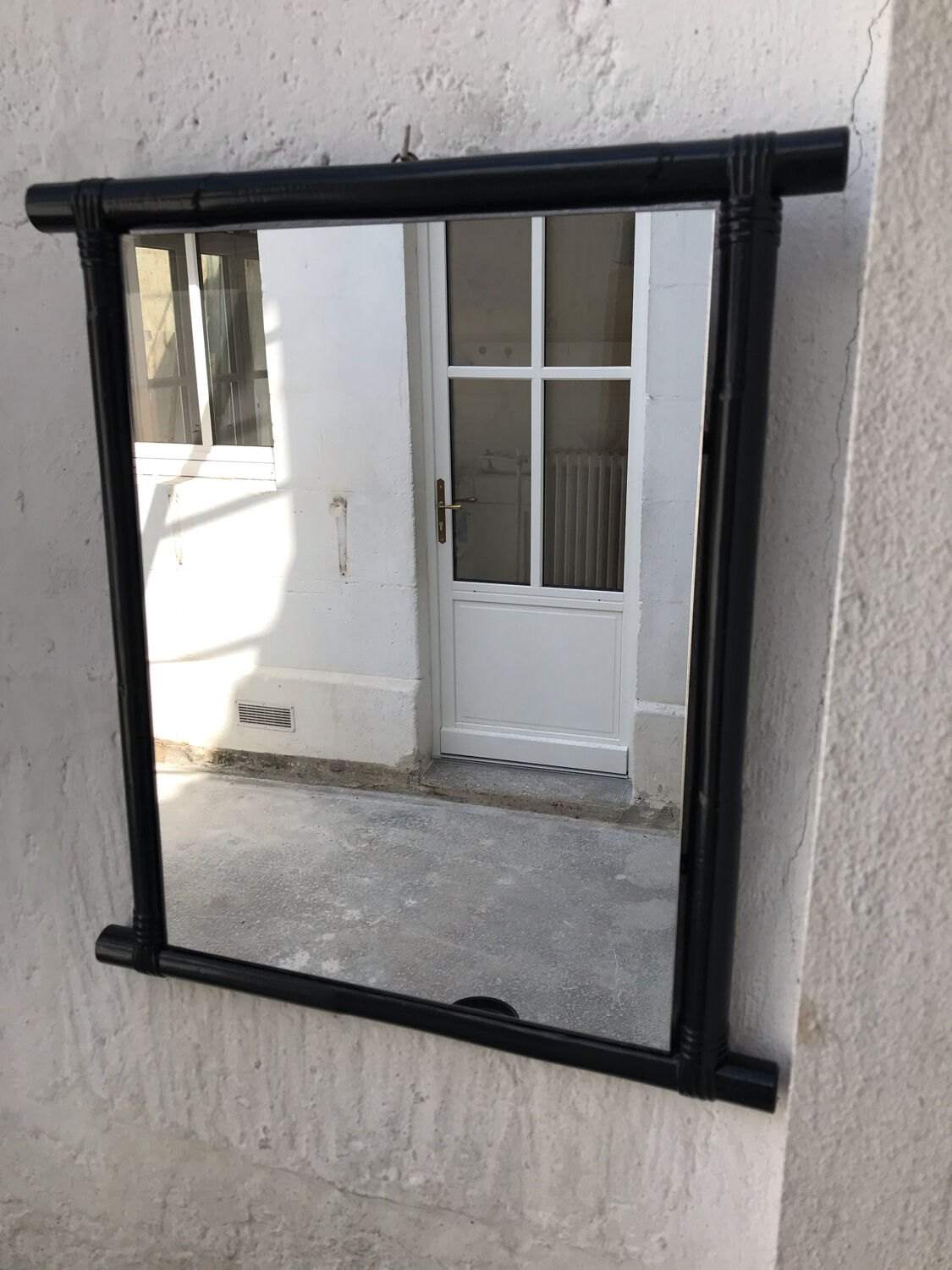 Black lacquered rattan mirror