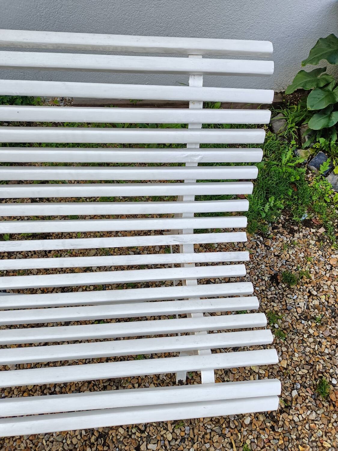 Old garden bench with metal legs and wooden slats