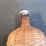 Set of two glass and wicker bottles