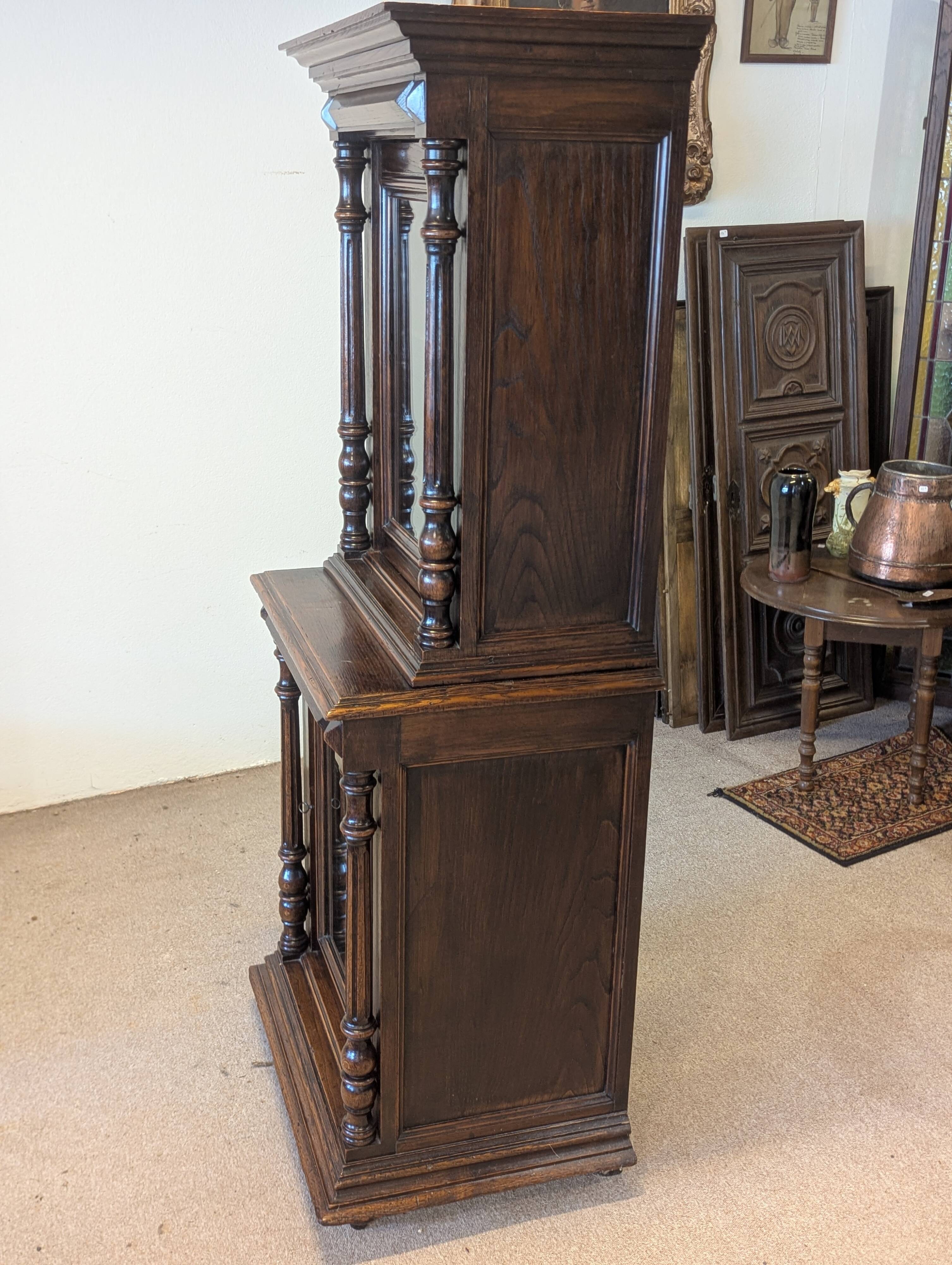 Two-body display cabinet in oak, Henri II style.