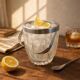 Small transparent crystal ice bucket Demeyere with stainless steel handle.
