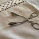 Sugar tongs or sweets in silver metal
