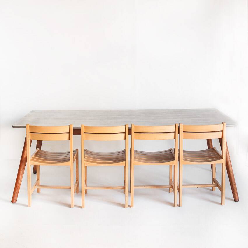 Scandinavian style dining table. Polished and varnished wood and concrete. For indoor or outdoor use.