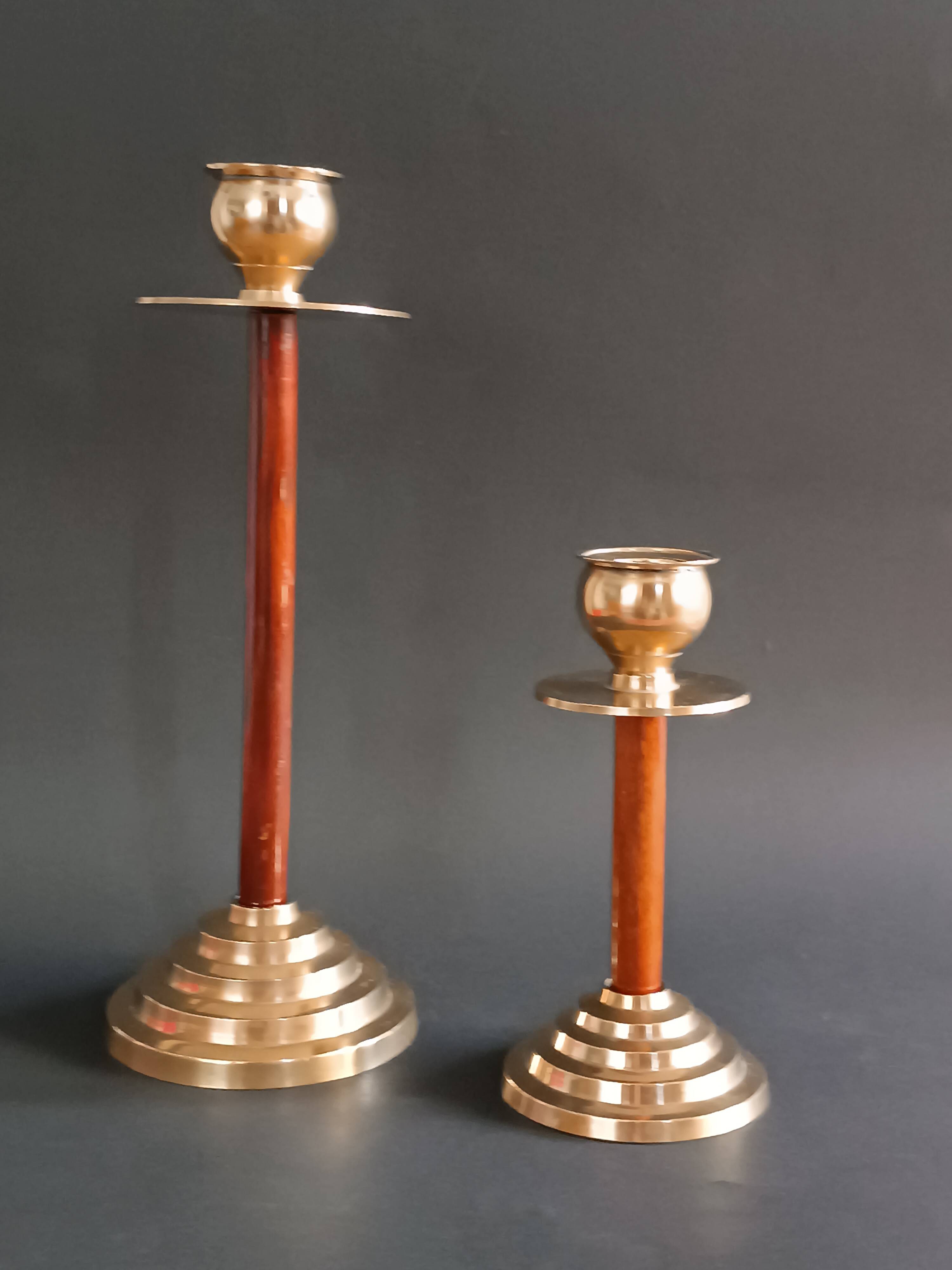 Two vintage wooden and brass candlesticks.