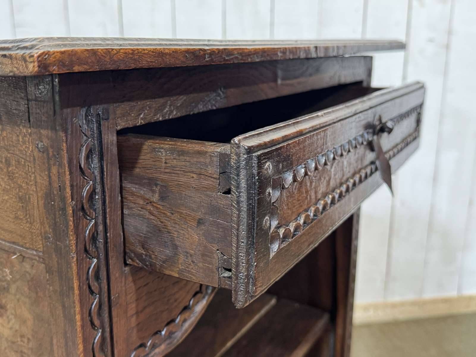 Oak accent furniture bookshelf with a drawer, early 20th century work.