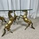 Hollywood Regency style coffee table, 6 patinated brass horses and glass top, 1970.