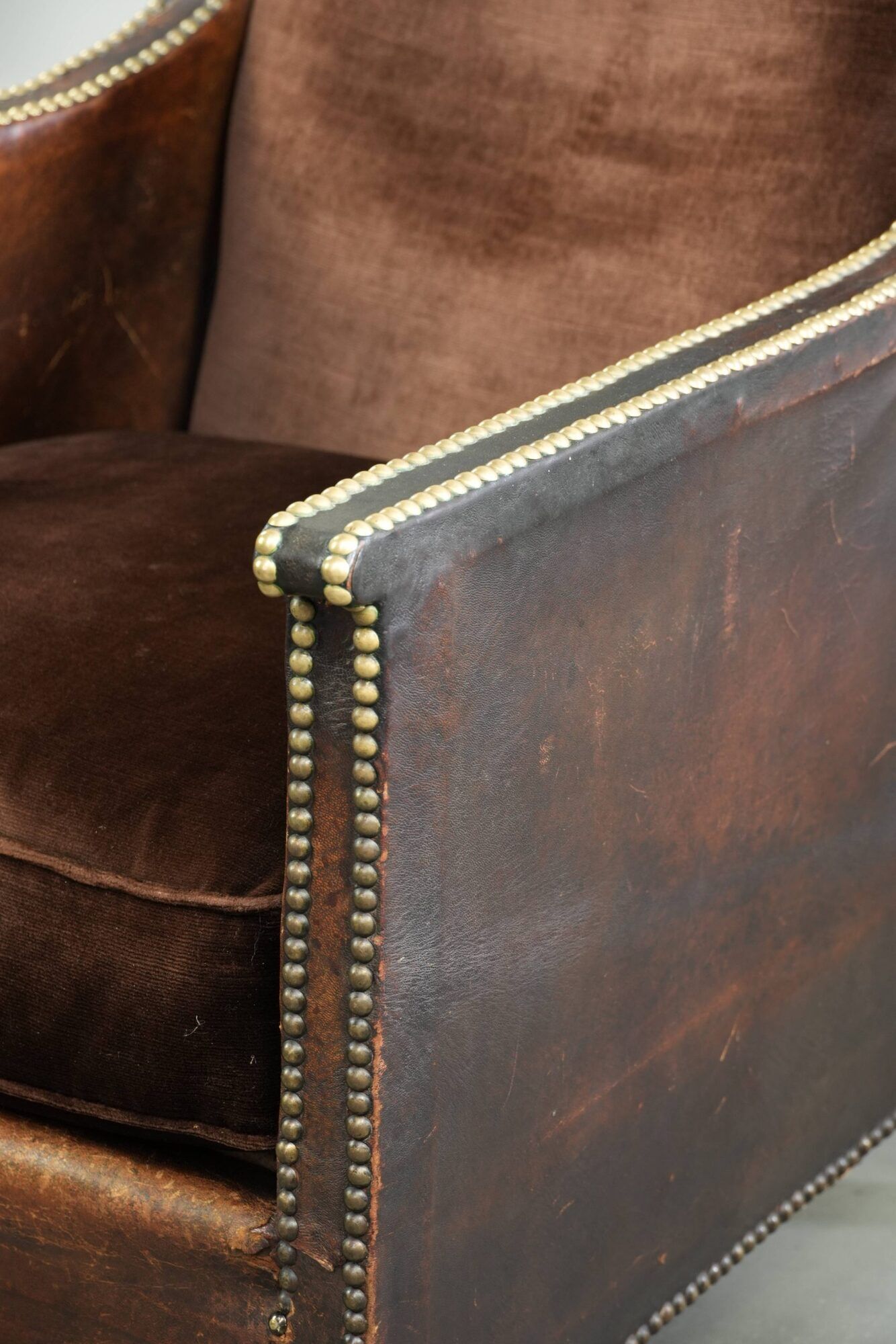 Art Deco design armchair finished in velvet and fitted with decorative nails