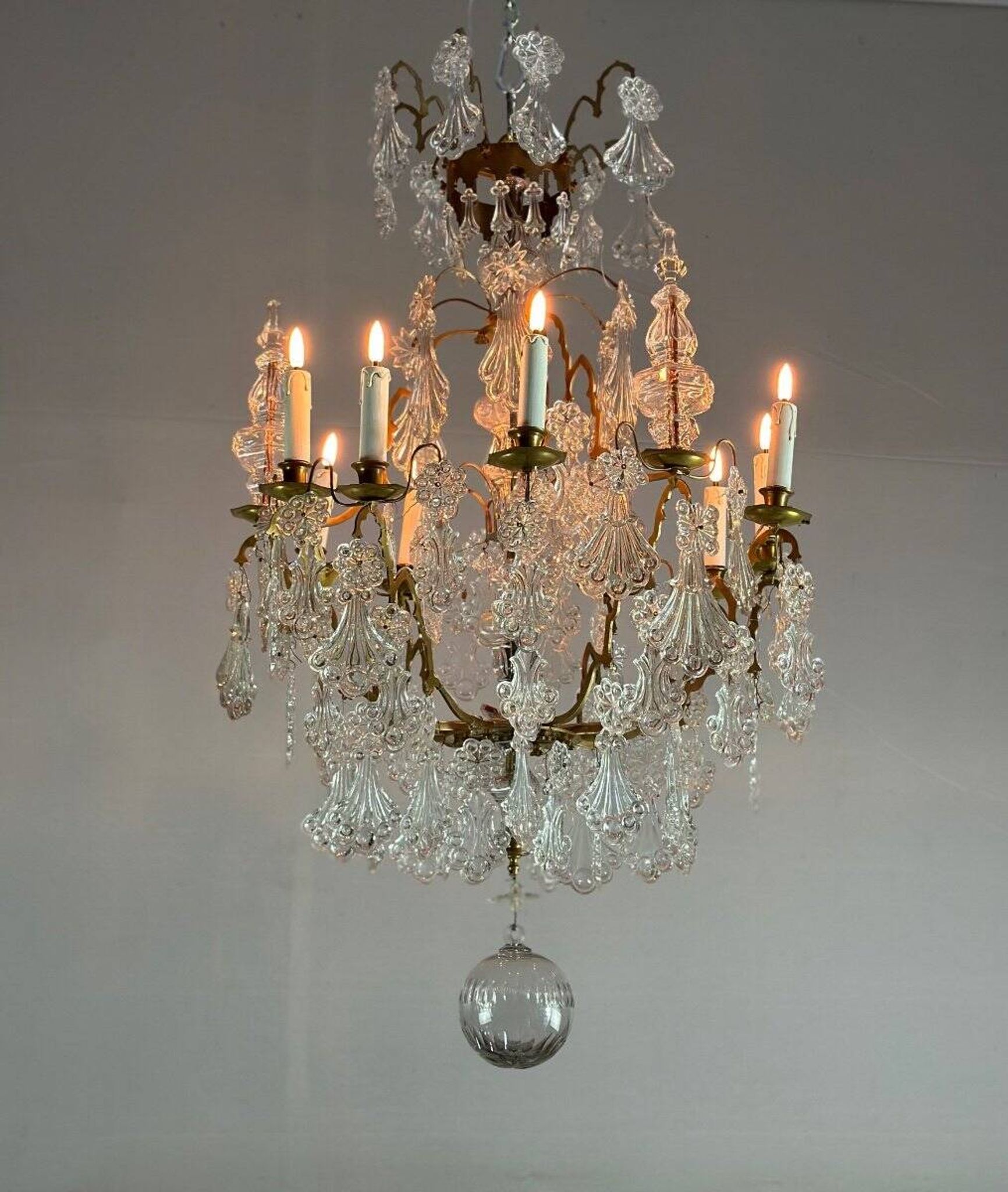 Bronze cage chandelier adorned with molded glass pendants in the shape of peacock feathers, circa 1800