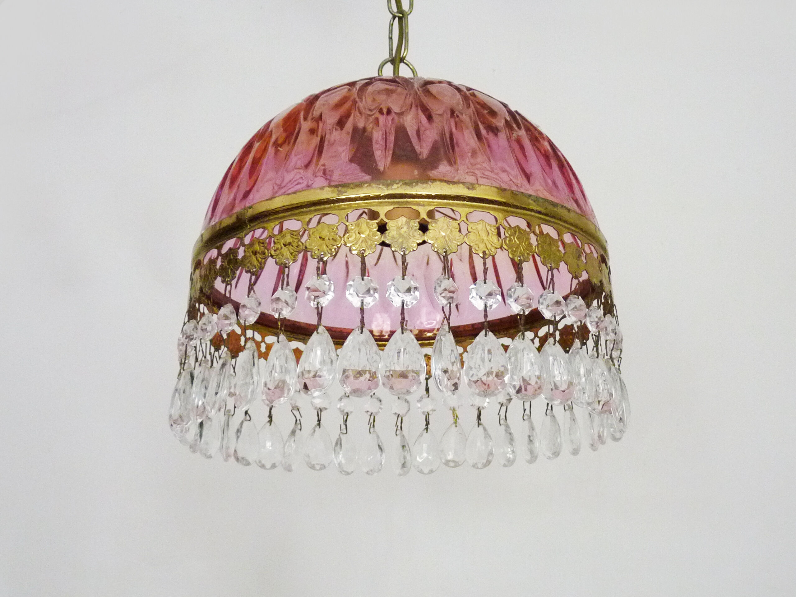 Vintage rose pendant light with pendants and patterned glass globe.